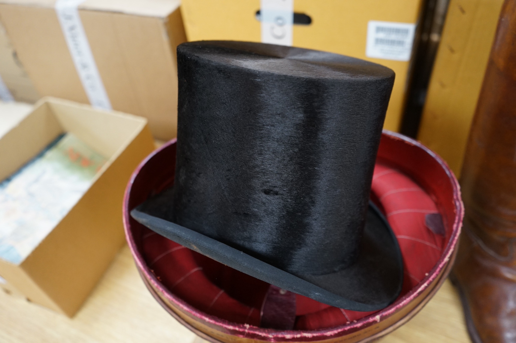 A pair of vintage leather riding boots and a leather cased top hat, ‘A.J. White, hatter to the Royal Family’. Condition - fair